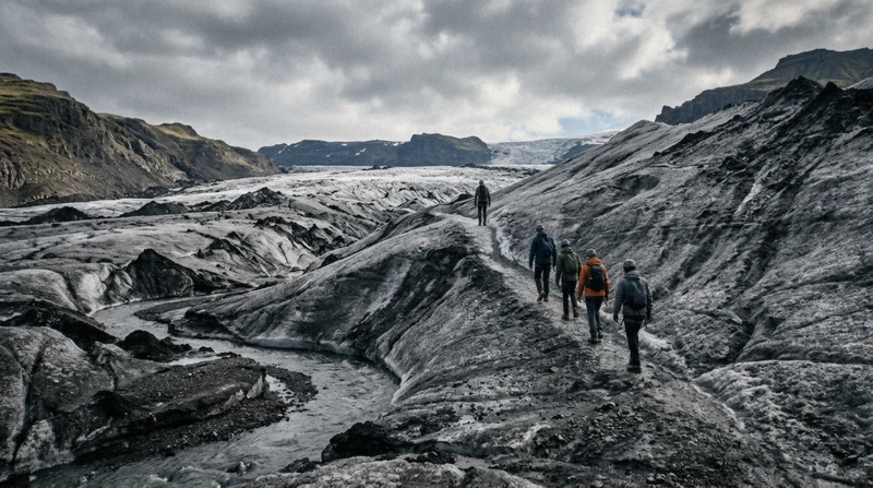 Certified guide leading hikers past an ash-streaked ice ridge on a four-hour Sólheimajökull glacier hike, South Iceland